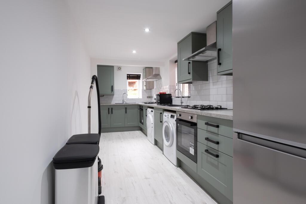 Modern kitchen featuring ample storage, sleek c...