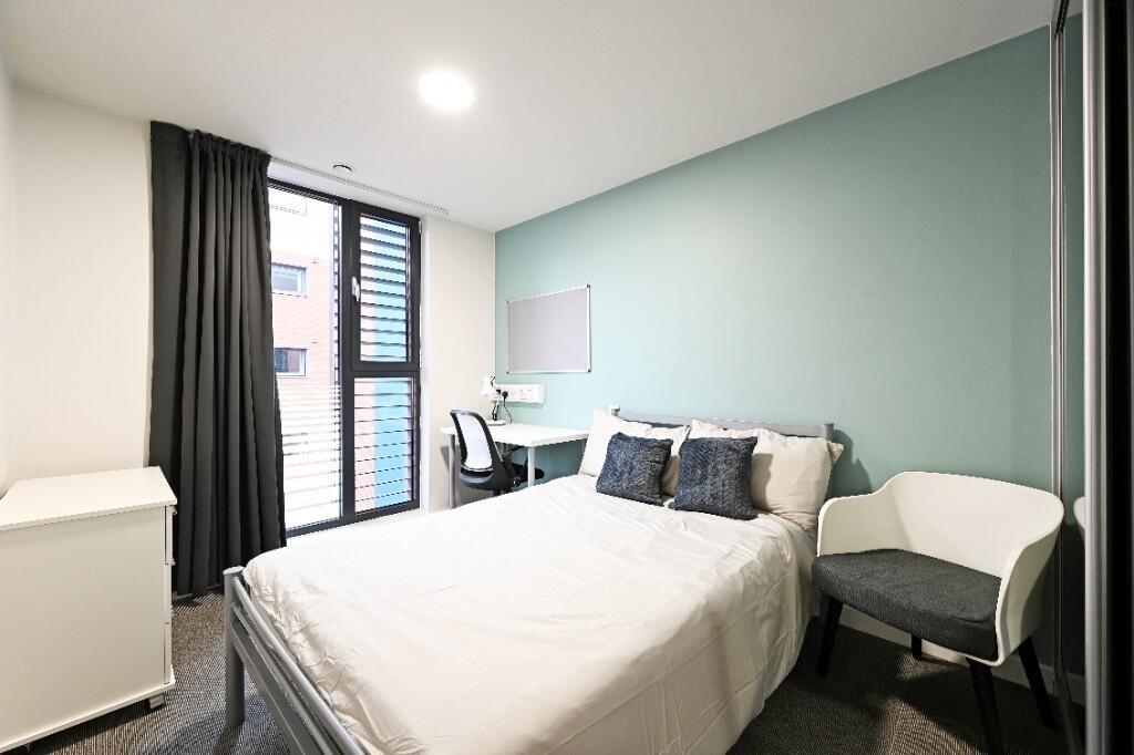 A modern, well-lit double bedroom featuring a c...