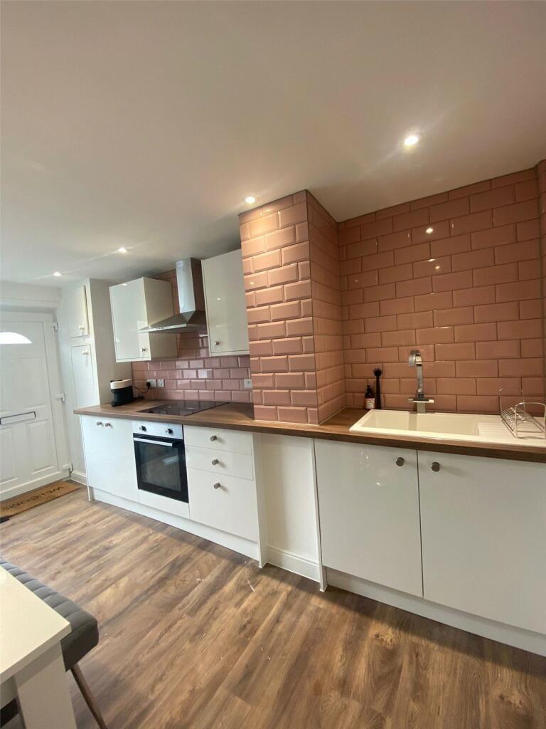 A modern, well-maintained kitchen featuring whi...