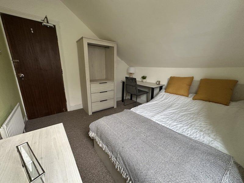 A cozy double bedroom featuring a comfortable d...