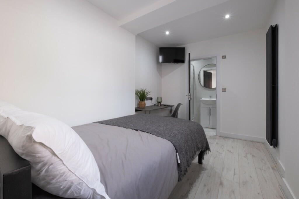 A beautifully designed double bedroom featuring...