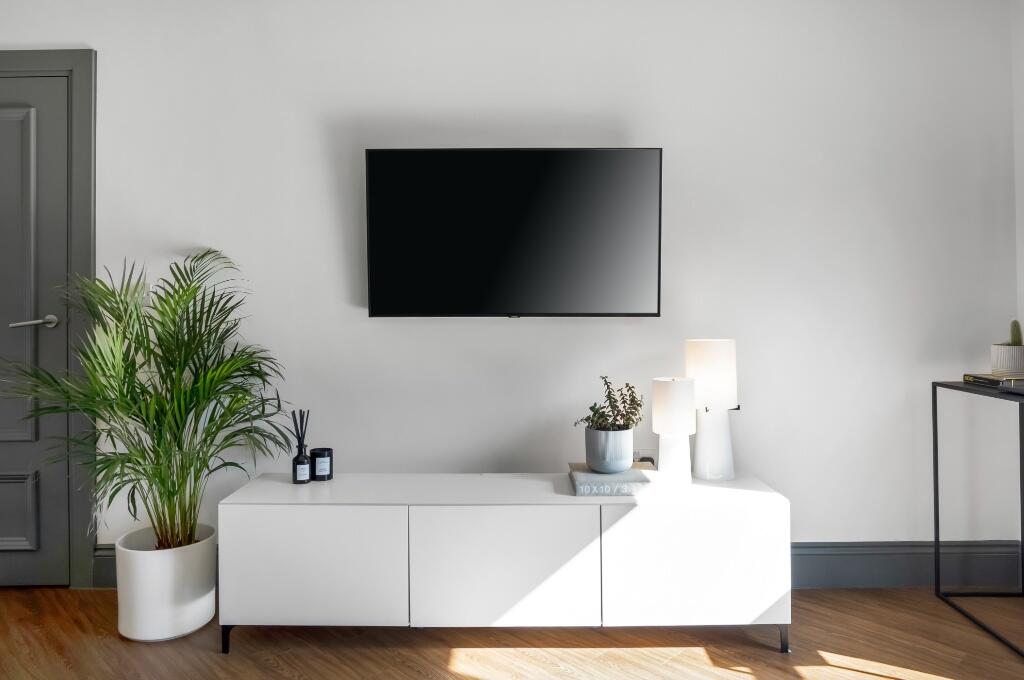 A modern living room featuring a sleek wall-mou...