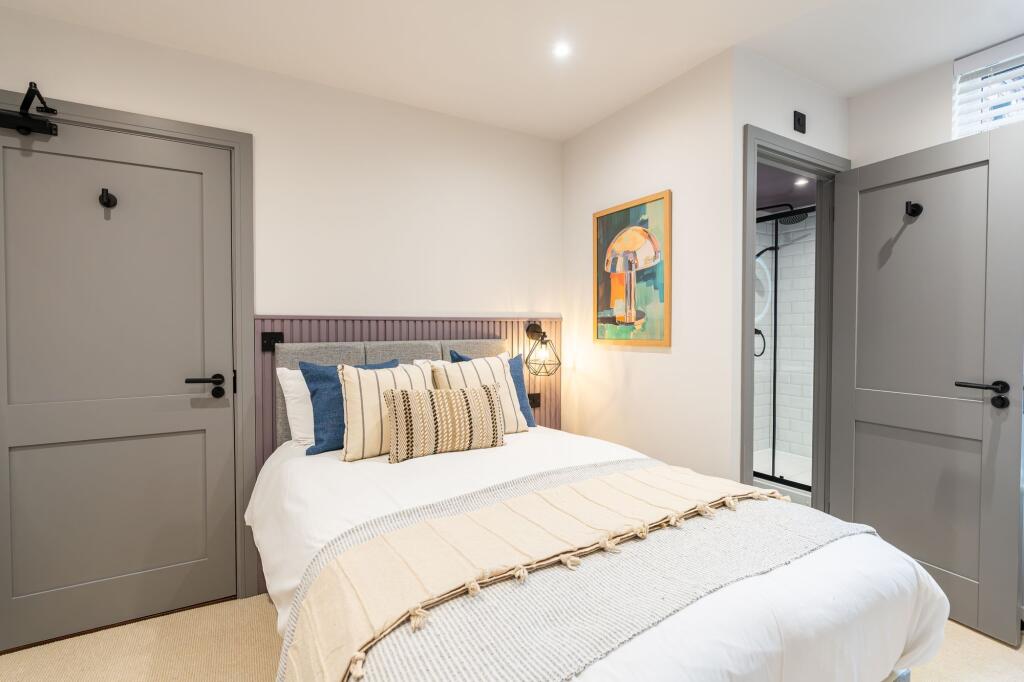 A bright and inviting master bedroom featuring ...