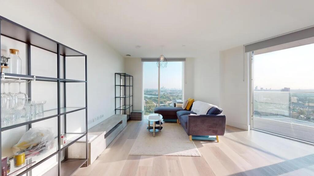 Bright and modern living room featuring a large...