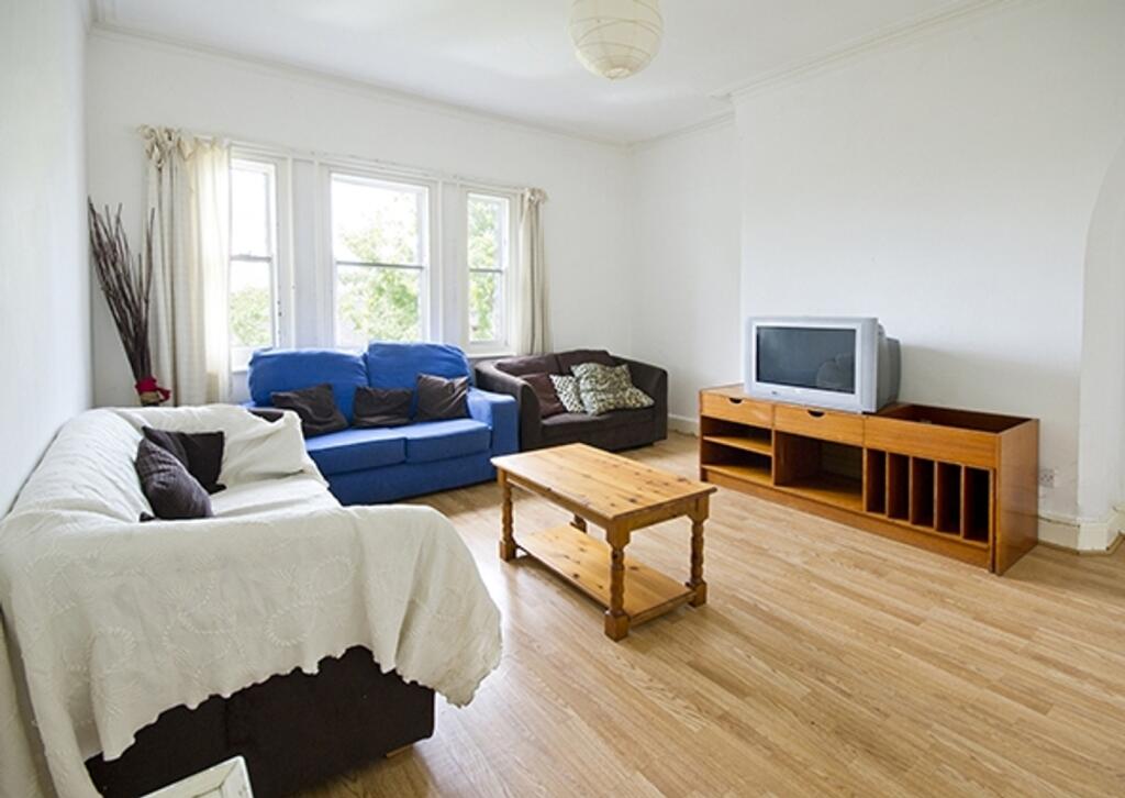 A spacious and well-lit modern living room, per...