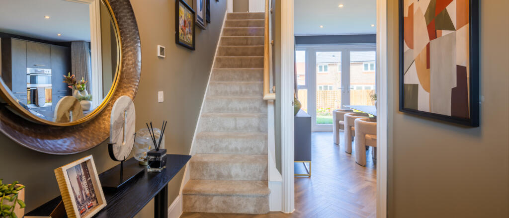 Redrow hallway featuring staircase and doorway into the open plan kitchen dining area