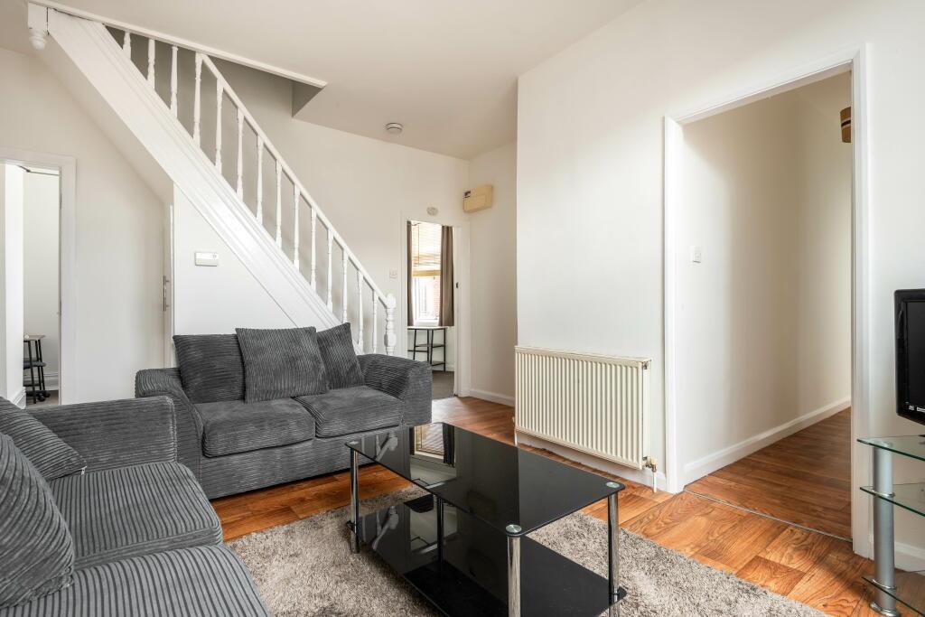 A cozy living room featuring comfortable grey s...