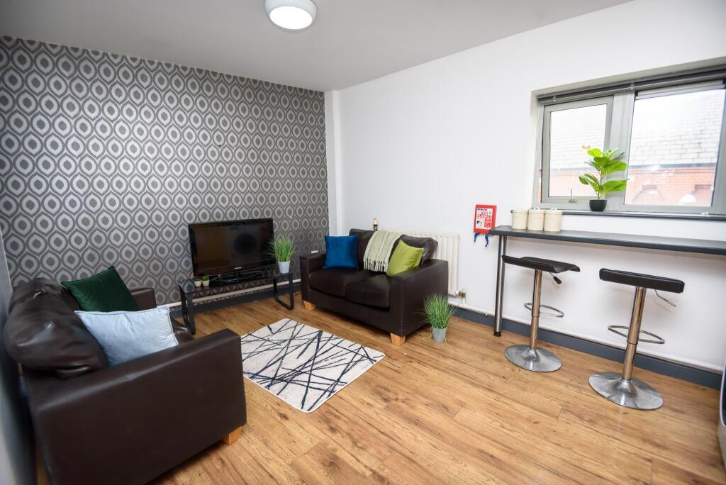 A modern living room featuring comfortable dark...