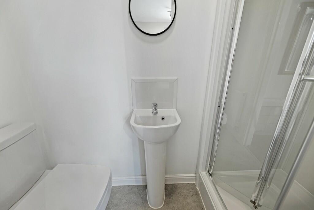 Bright and clean bathroom featuring a modern pe...