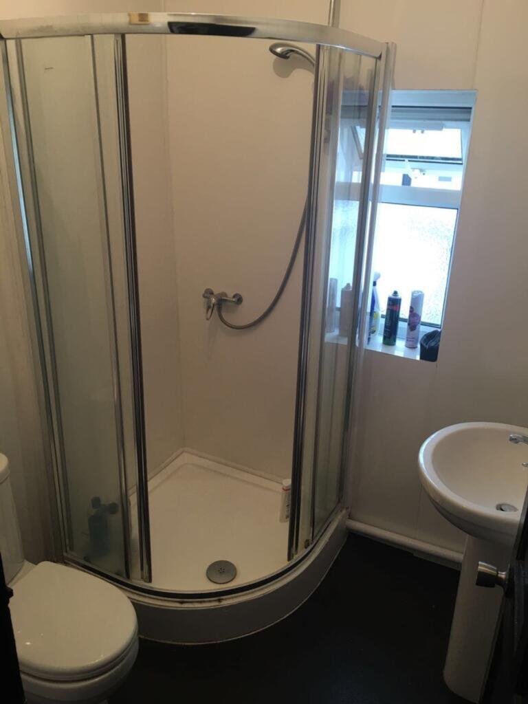 This modern bathroom features a sleek shower en...