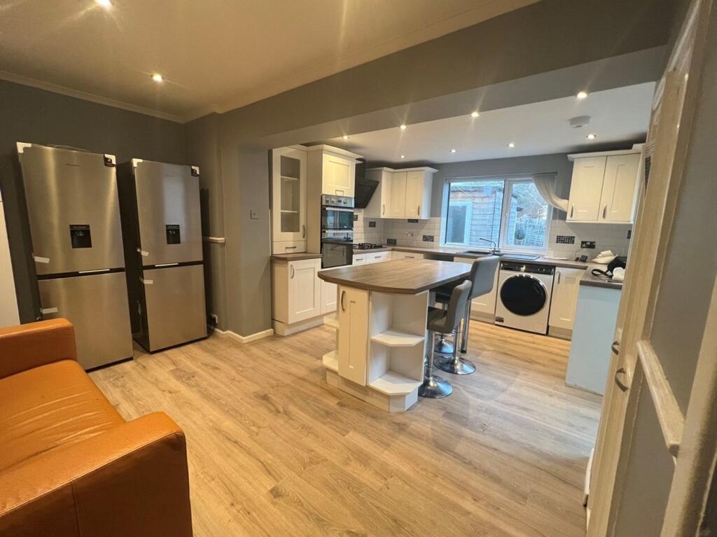 A modern and spacious kitchen with ample storag...