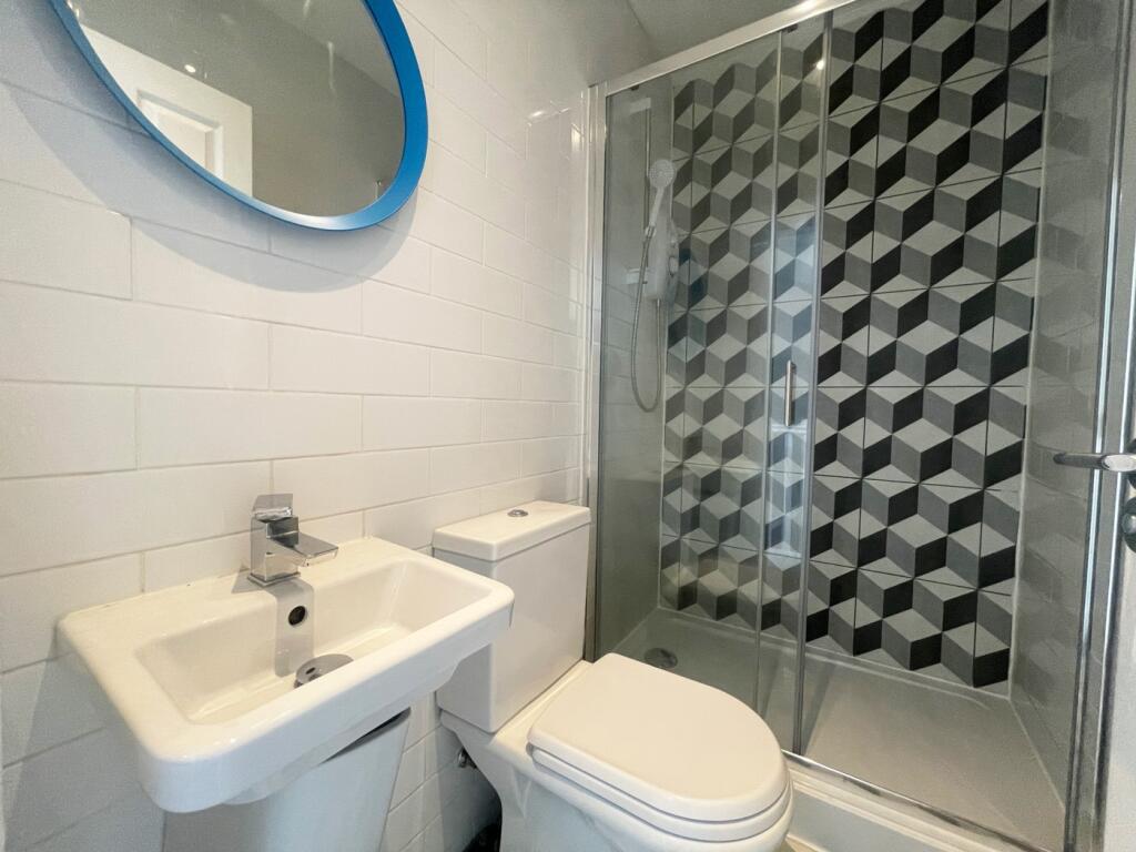 A modern and stylish bathroom featuring a sleek...