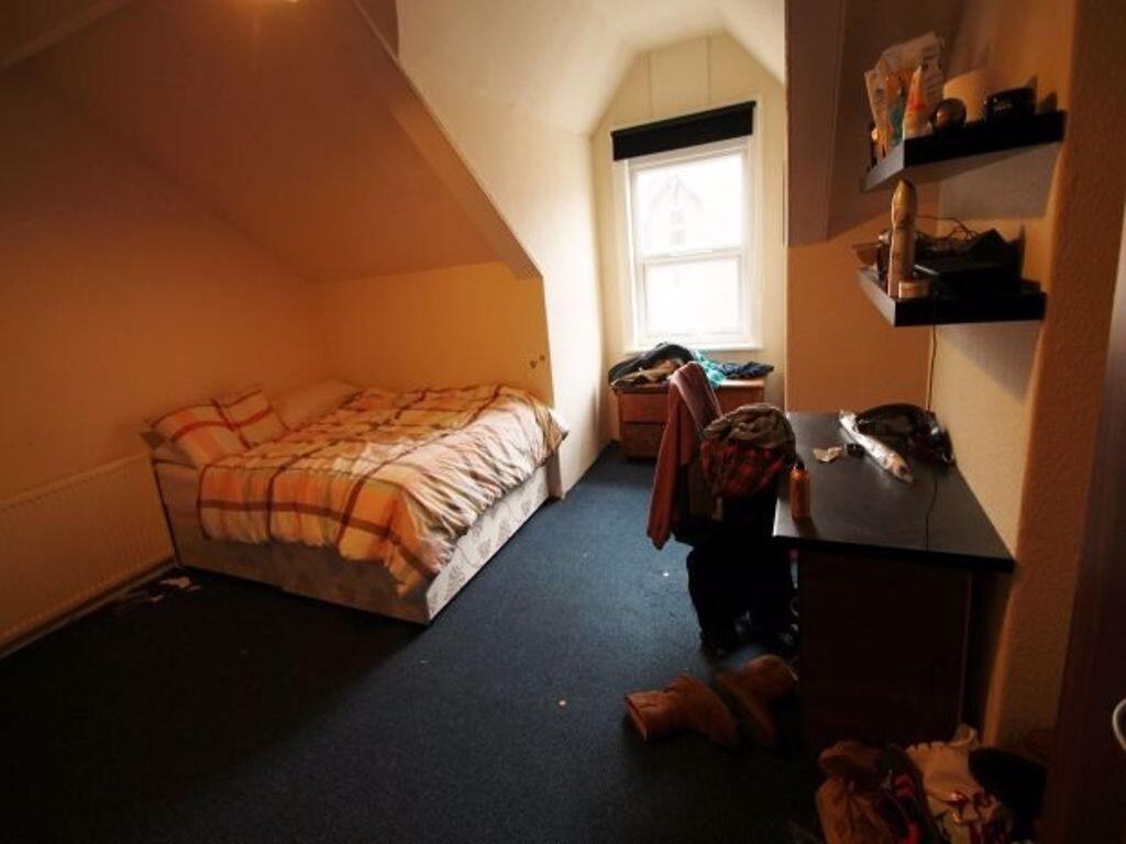 Cozy single bedroom with a comfortable bed, a d...