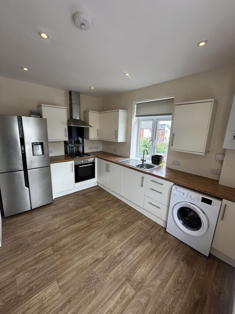 This modern kitchen features ample cabinetry an...