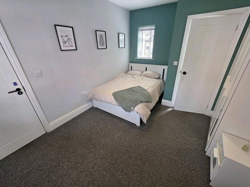 Bright and cozy double bedroom featuring a comf...
