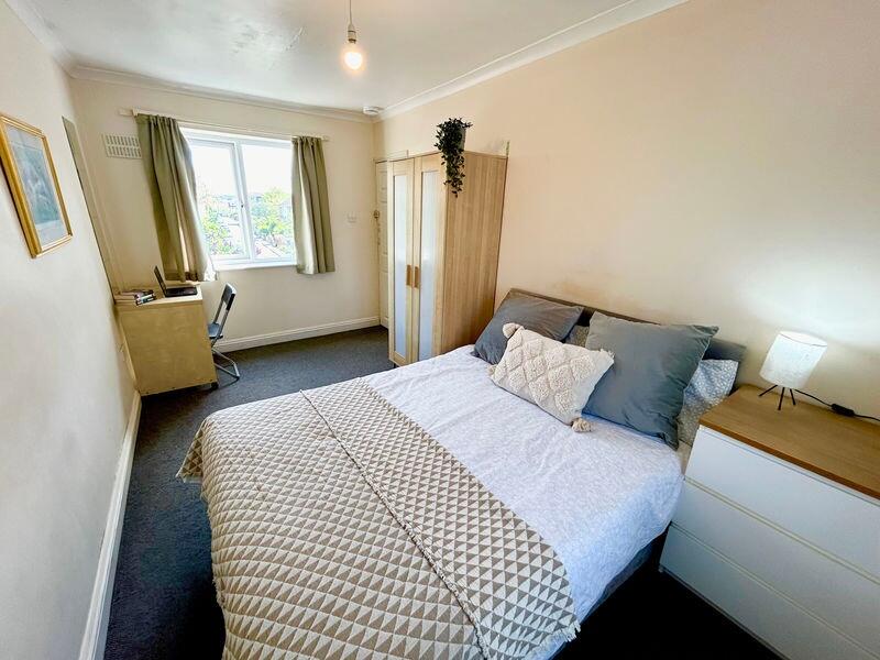 This inviting double bedroom features a cozy la...