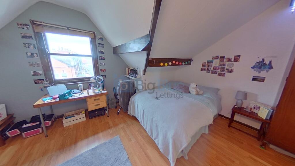 Cozy master bedroom featuring a comfortable dou...
