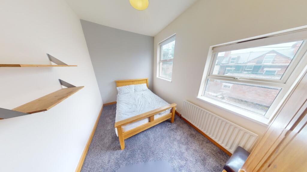 A bright and inviting double bedroom with large...