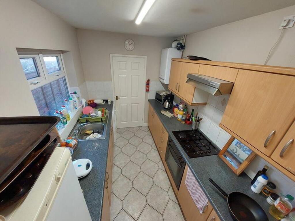A compact kitchen featuring essential appliance...
