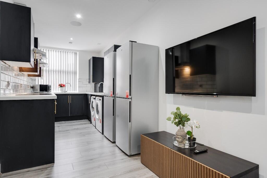 Modern kitchen featuring sleek appliances and a...