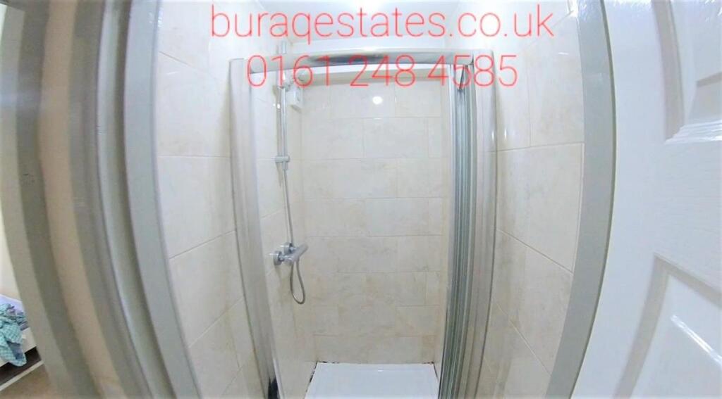 Modern tiled shower enclosure with clear glass ...