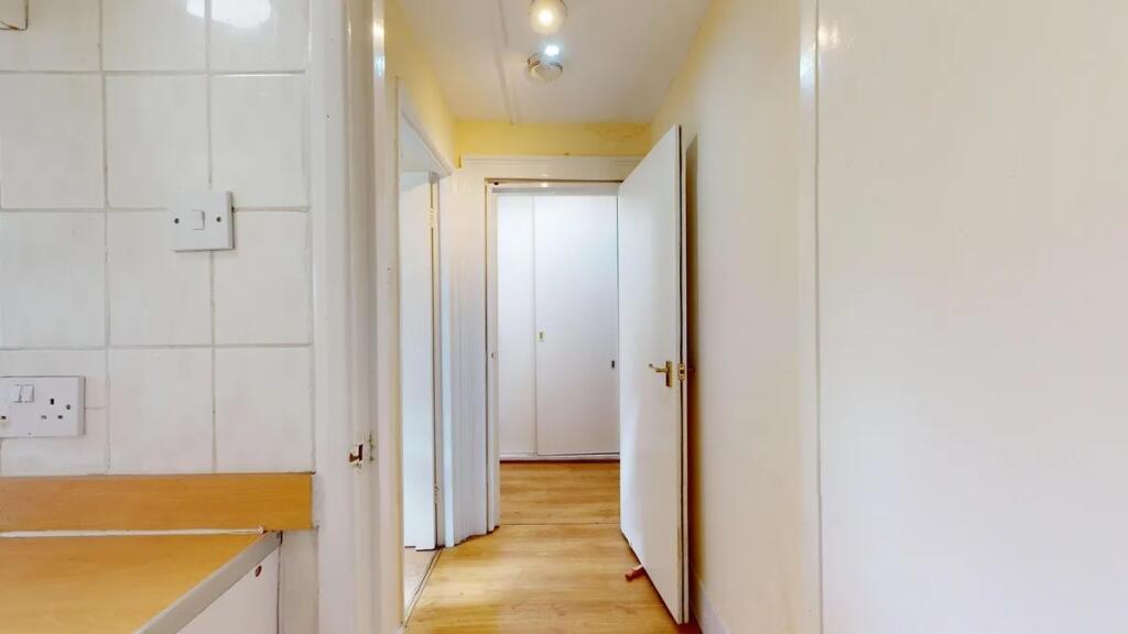A clean and simple hallway with wooden flooring...