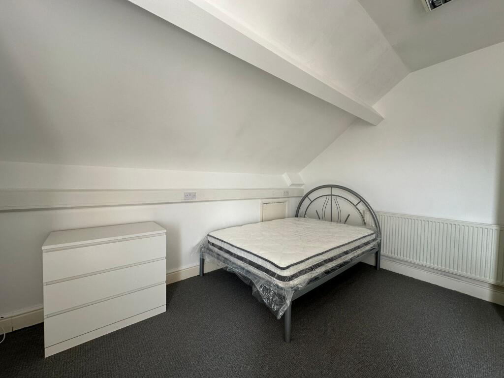 A tidy double bedroom featuring a modern metal ...