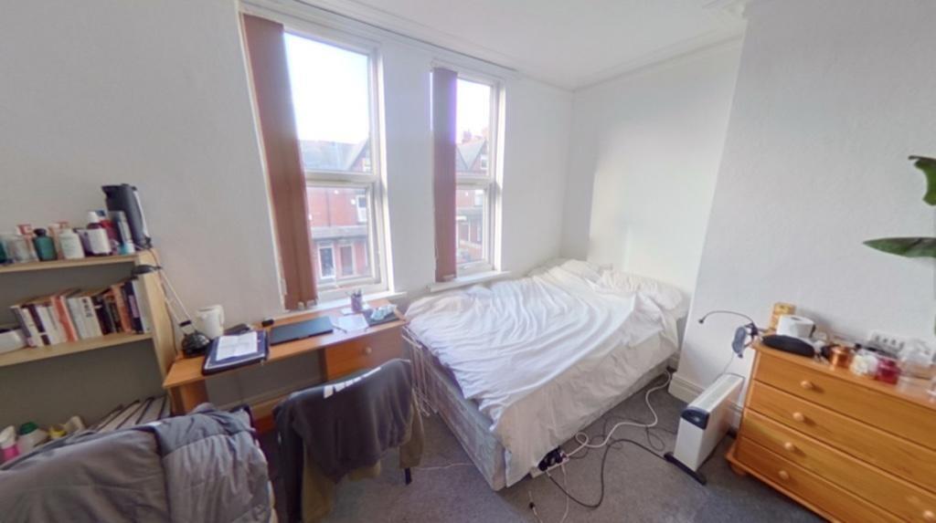 Bright and inviting master bedroom with a comfo...