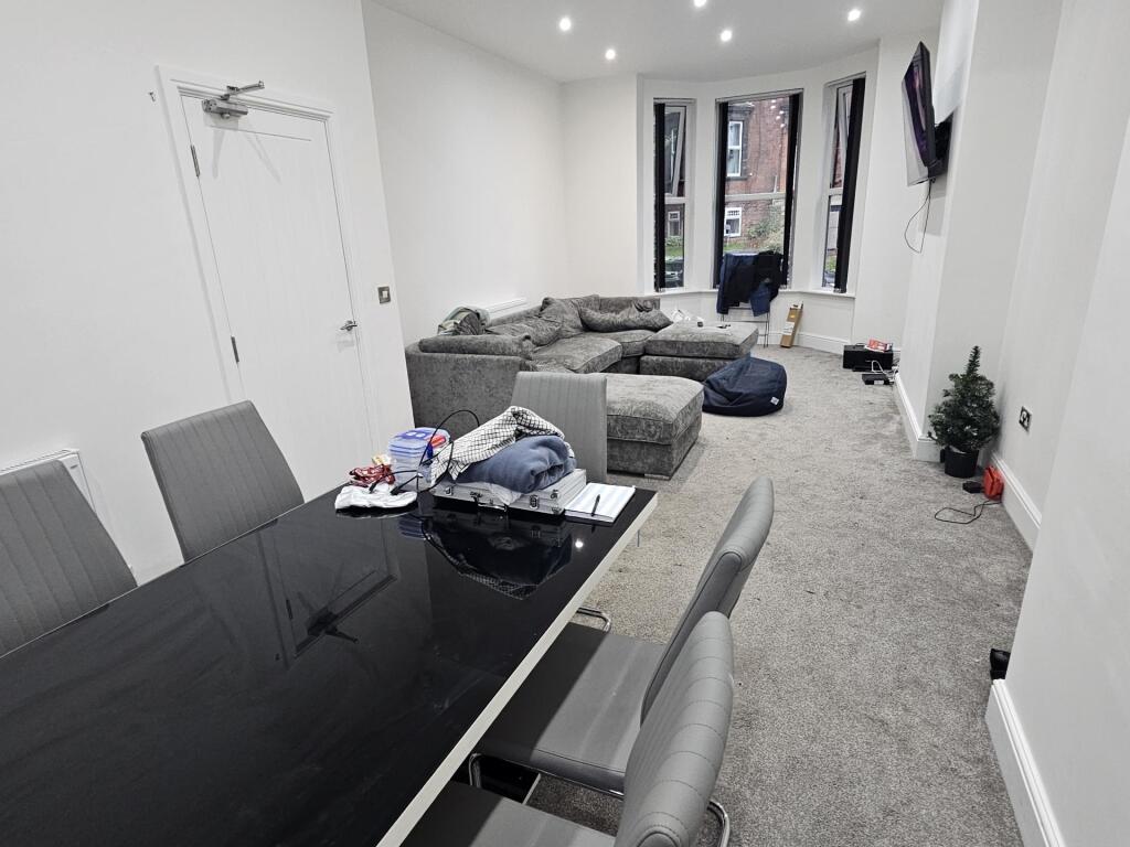 A spacious and modern living room featuring amp...