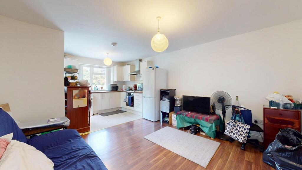 A bright and inviting living room featuring woo...