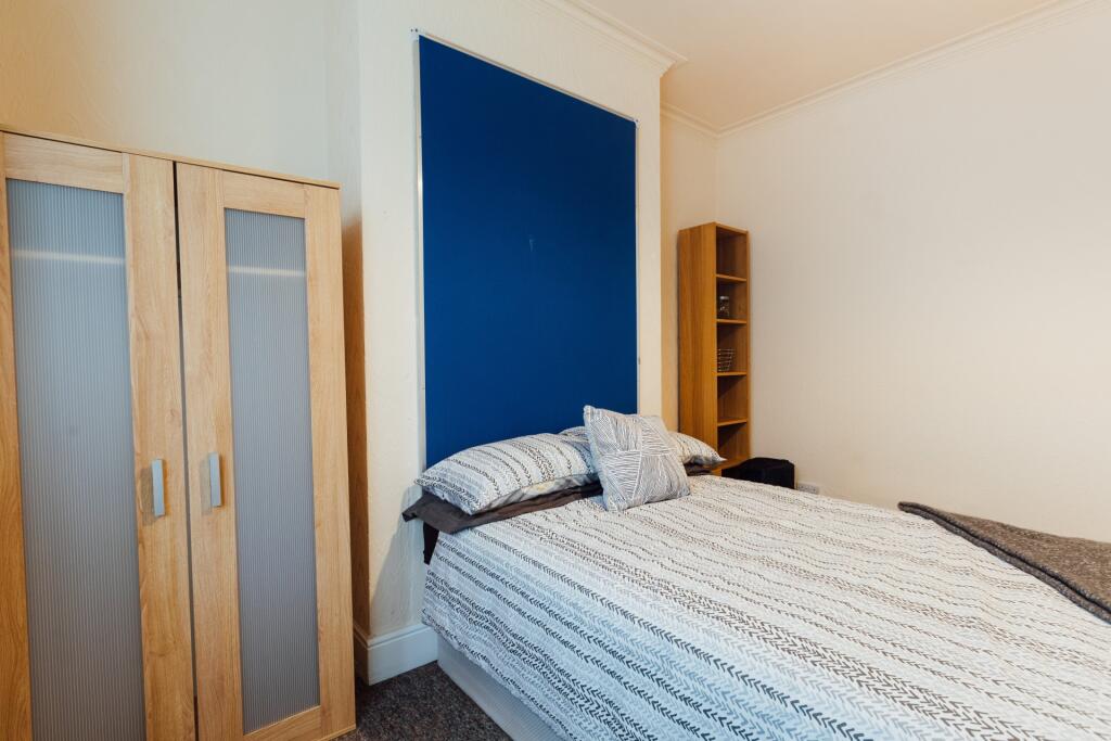 A bright and inviting double bedroom featuring ...