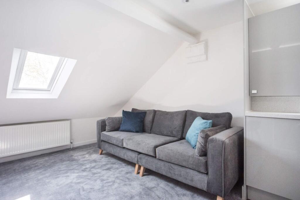 This contemporary living room features a cozy s...