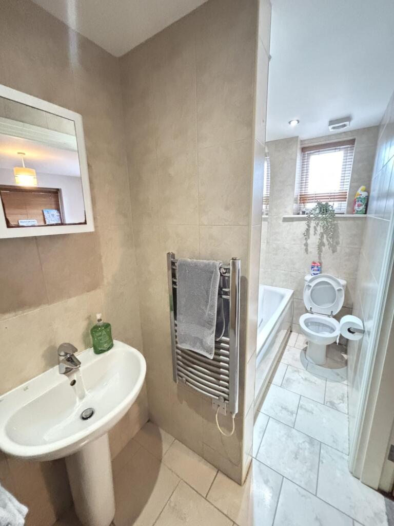 A clean and well-maintained bathroom featuring ...