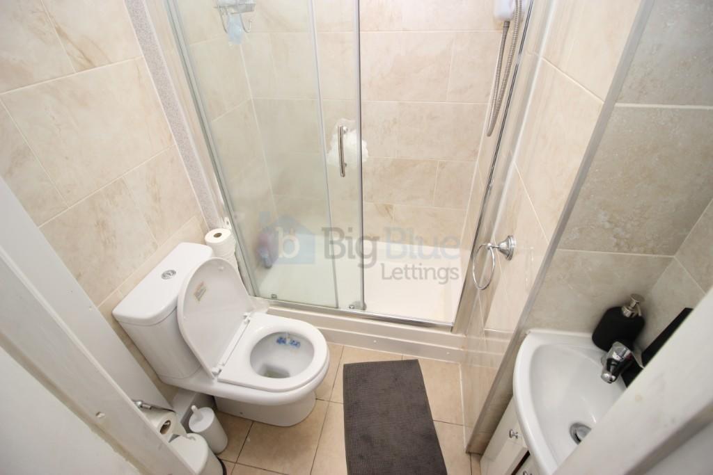 A modern bathroom featuring a glass-enclosed sh...