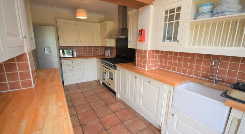 A charming kitchen featuring ample counter spac...