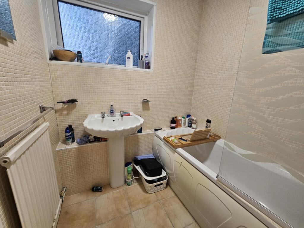 A clean and well-maintained bathroom with a bat...