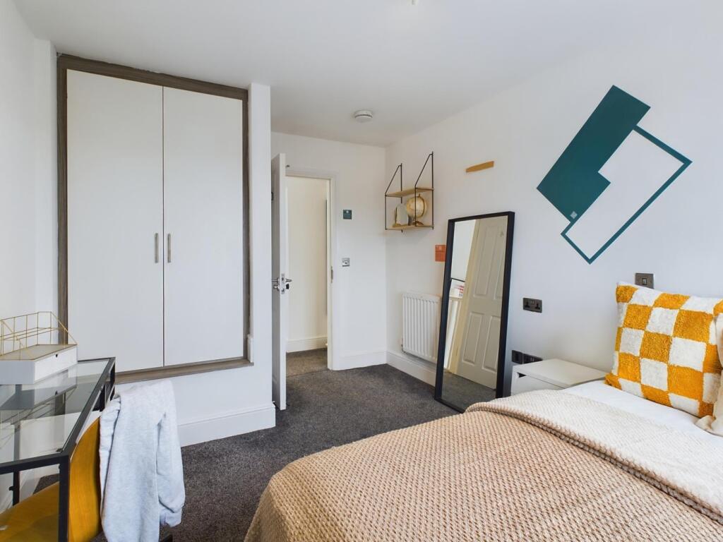 A bright and inviting double bedroom featuring ...