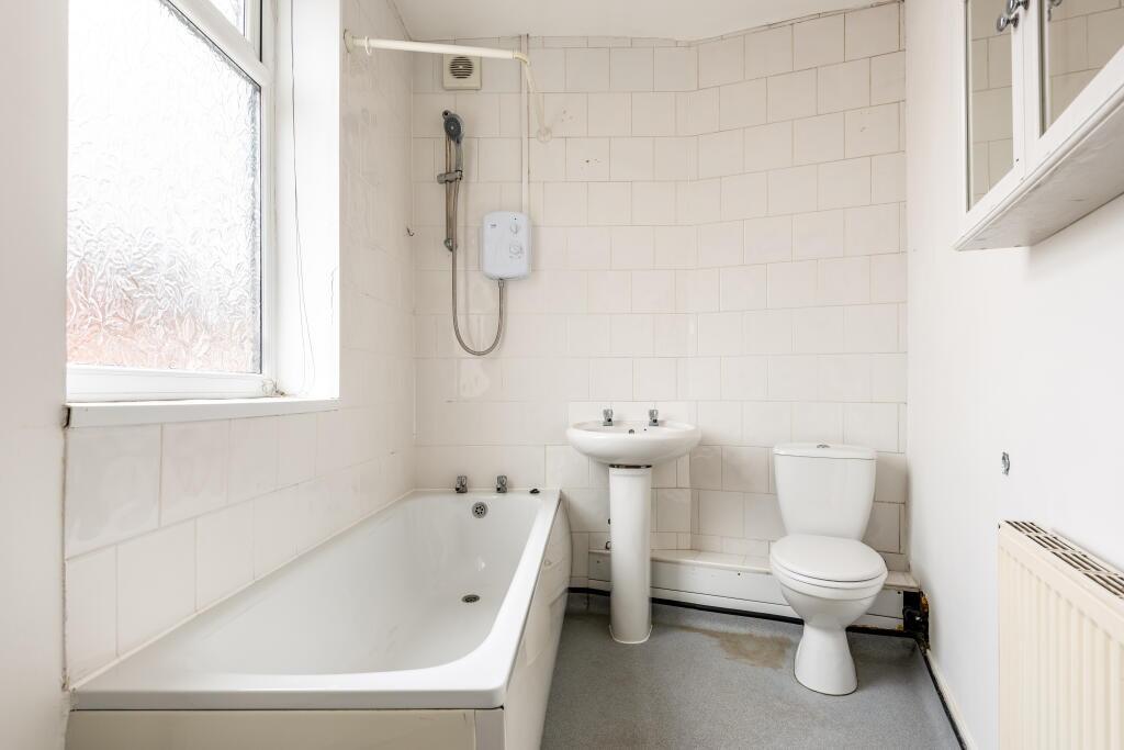 Bright and clean bathroom featuring a full-size...