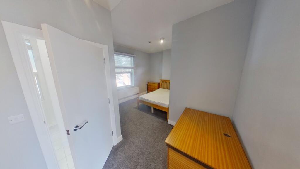 A spacious and inviting double bedroom with amp...