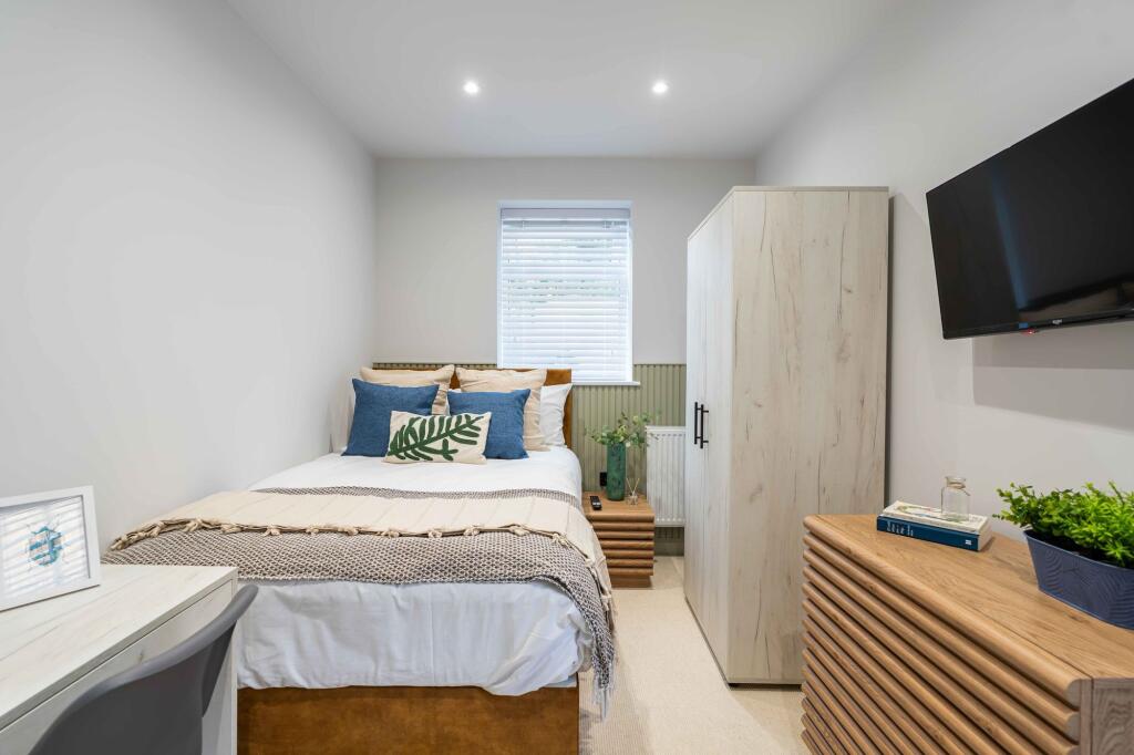 A bright and inviting master bedroom featuring ...