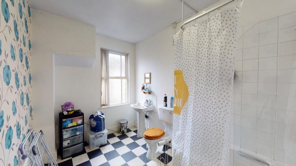 Bright and clean bathroom with classic black an...