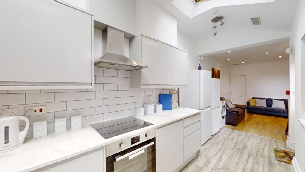 Bright and modern kitchen featuring sleek white...