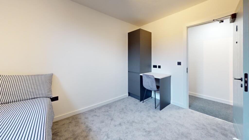 A bright and spacious double bedroom featuring ...