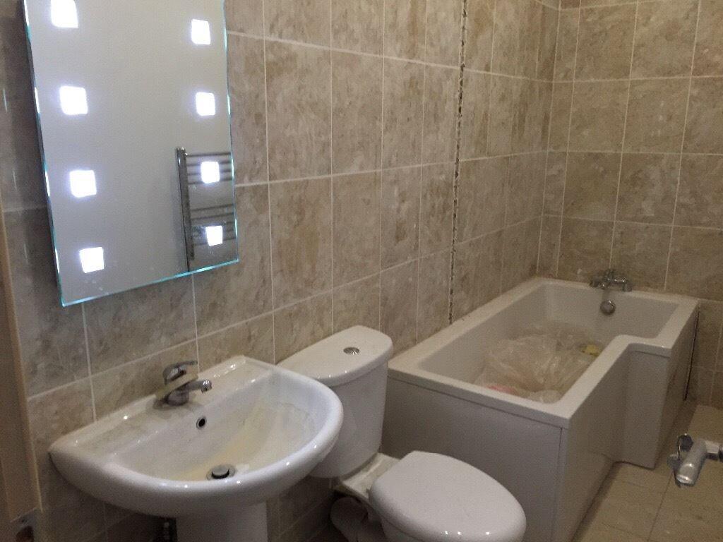 A well-maintained bathroom suite featuring a mo...