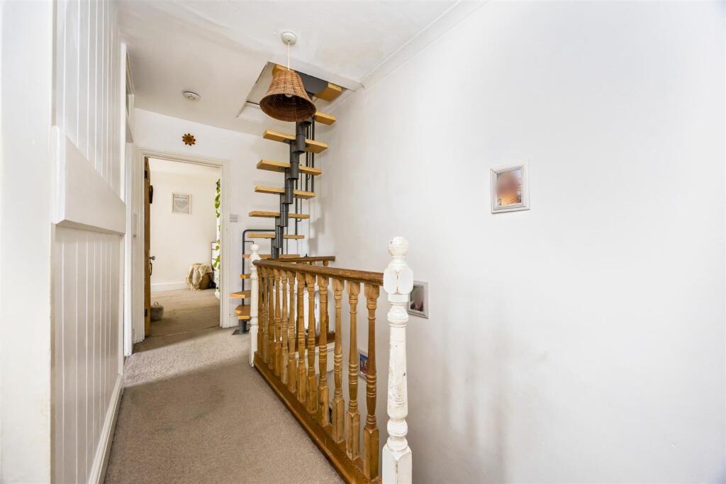 Stairs rising to Second Floor