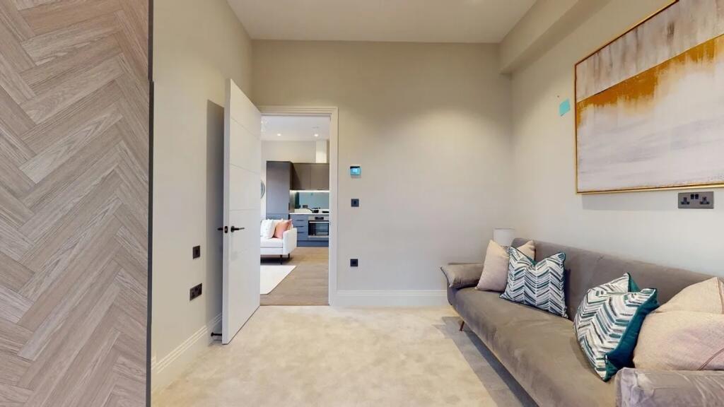 Contemporary living room featuring a plush grey...