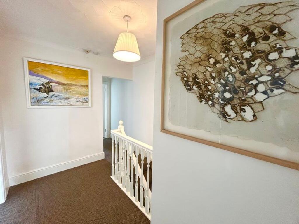 A bright and clean hallway featuring artistic d...