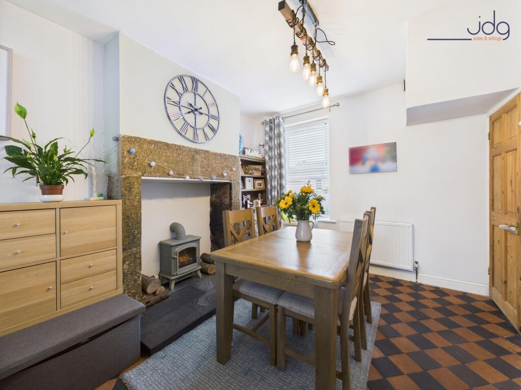 Spacious open-plan lounge diner and decorative fireplace with electric stove