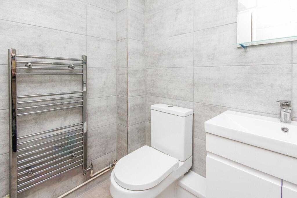 A modern and pristine bathroom featuring stylis...