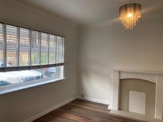 side view of living room with chandalier and windo